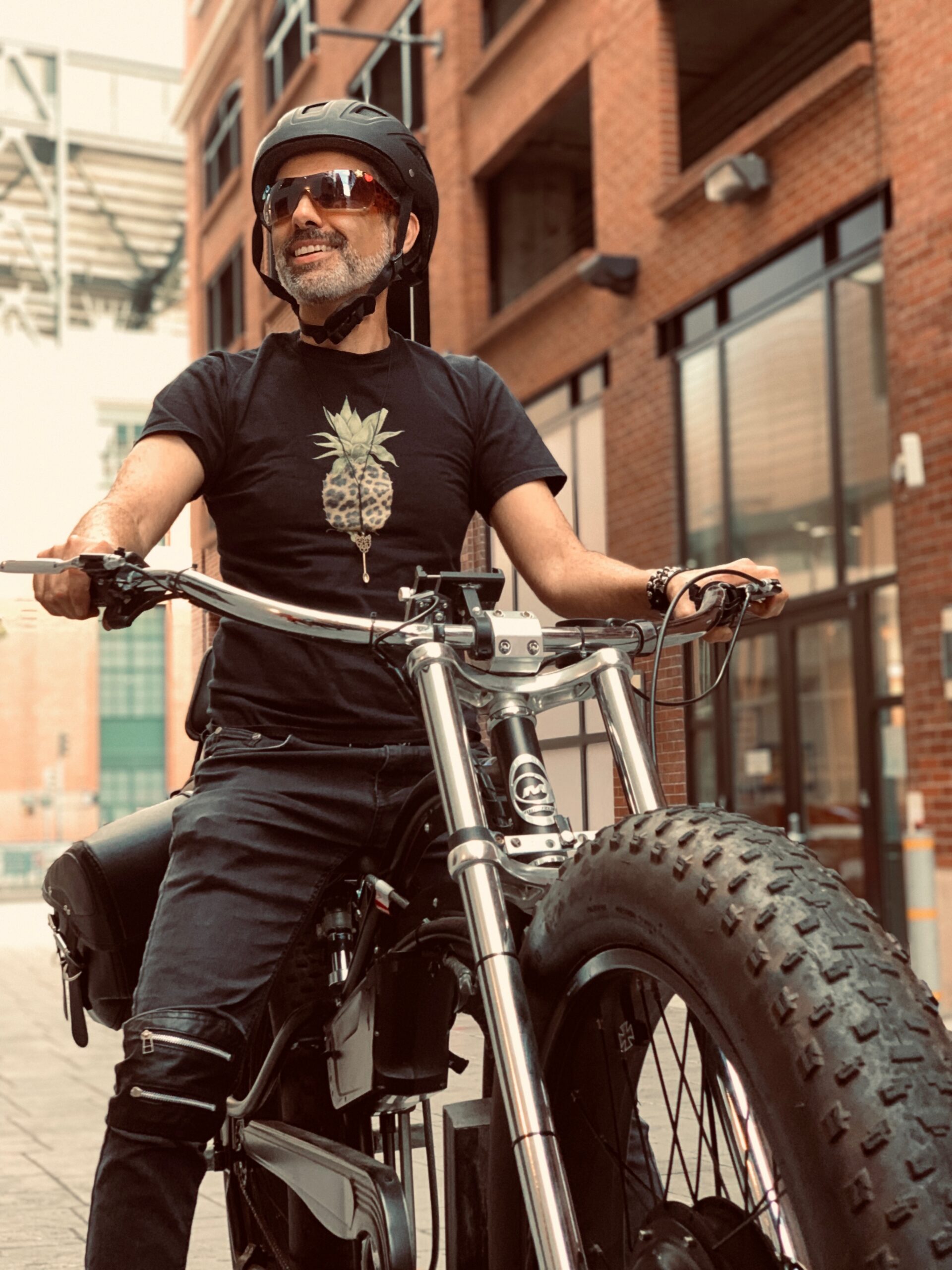 Rev Hooman on his e-bike in San Francisco